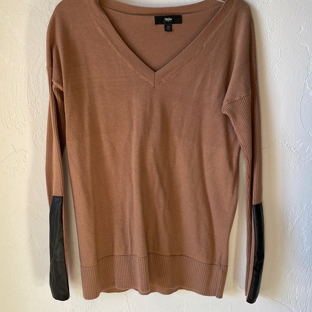 Size medium camel color sweater with black pleather cuff embellishment